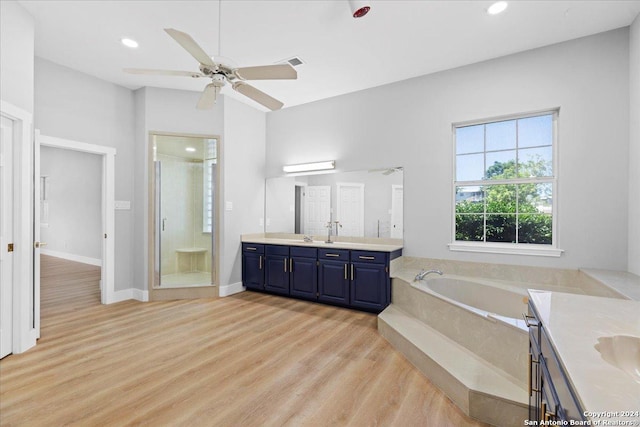 bathroom with separate shower and tub, ceiling fan, vanity, and hardwood / wood-style flooring