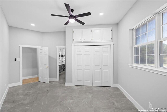 unfurnished bedroom featuring a closet and ceiling fan