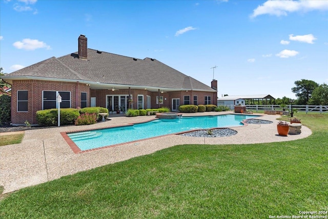 view of pool with a lawn, ceiling fan, and a patio