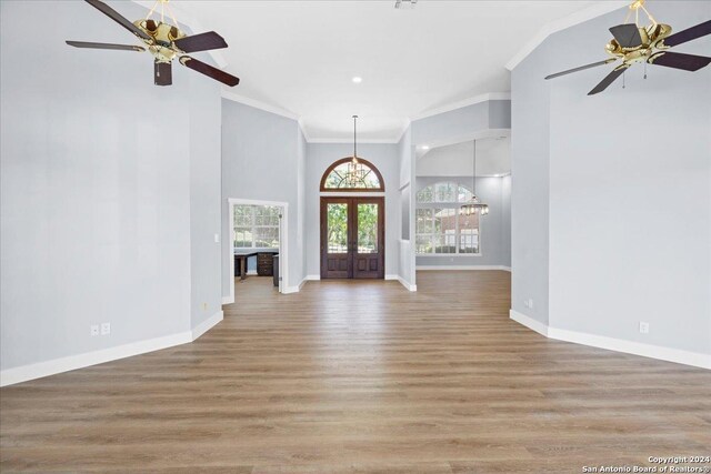 entrance foyer featuring ceiling fan, light hardwood / wood-style flooring, crown molding, and french doors