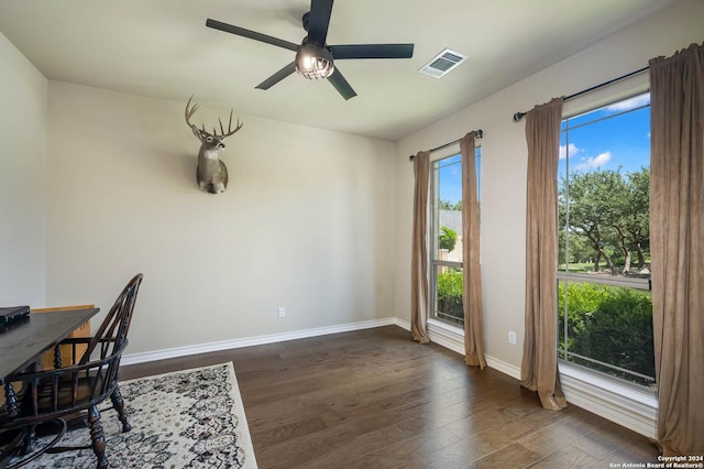 unfurnished office featuring dark hardwood / wood-style floors and ceiling fan