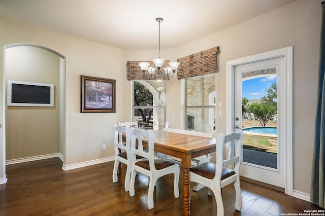 dining space featuring a chandelier and dark hardwood / wood-style flooring