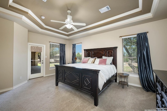 carpeted bedroom with ceiling fan, ornamental molding, a raised ceiling, and access to outside