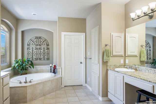 bathroom with tile patterned floors, vanity, tiled bath, and a chandelier