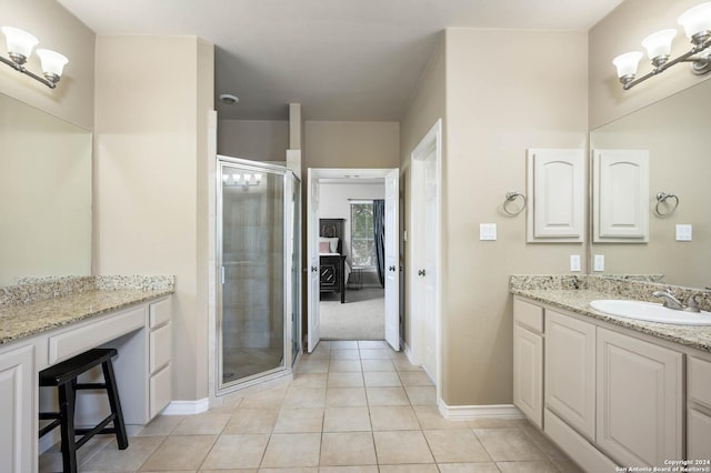 bathroom featuring tile patterned flooring, vanity, a chandelier, and walk in shower