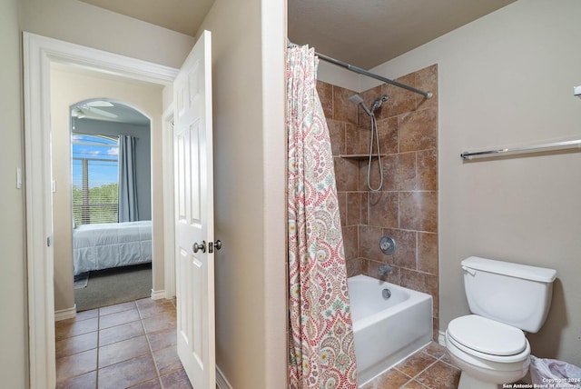 bathroom featuring tile patterned flooring, toilet, and shower / bath combo with shower curtain