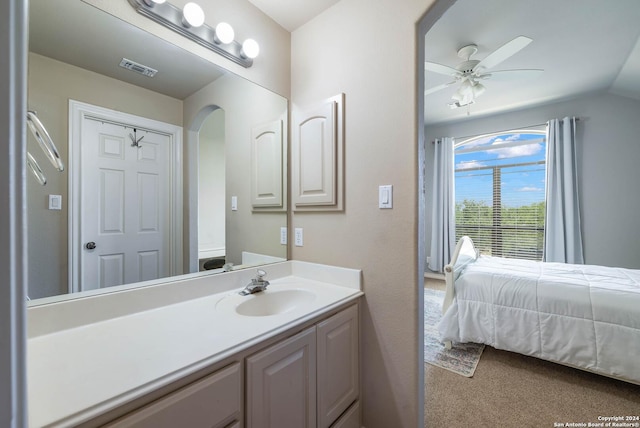 bathroom with ceiling fan, vanity, and lofted ceiling