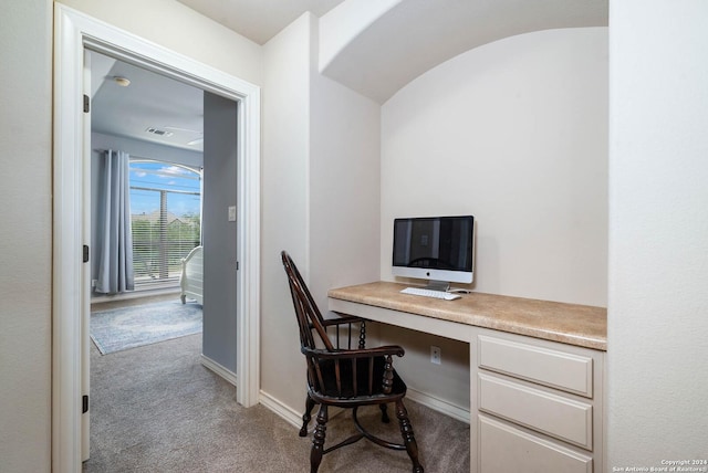 office with light colored carpet and built in desk