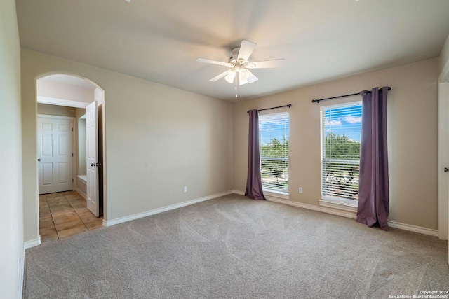 carpeted spare room with ceiling fan