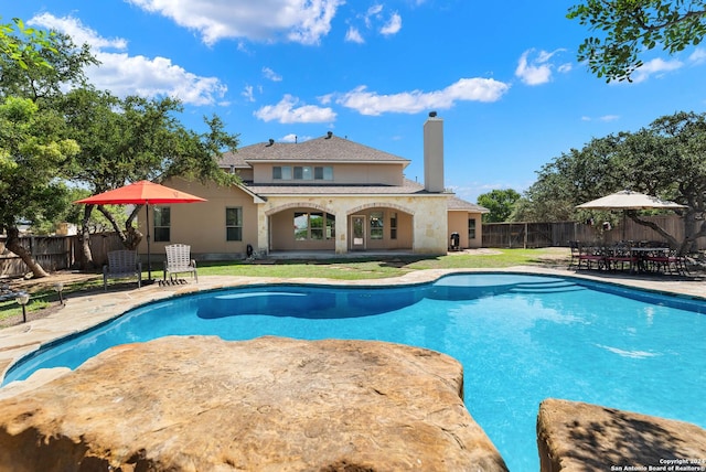 view of pool with a yard and a patio area