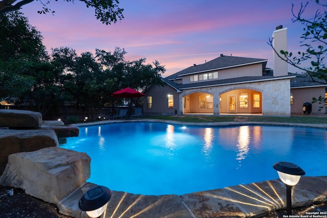 view of pool at dusk