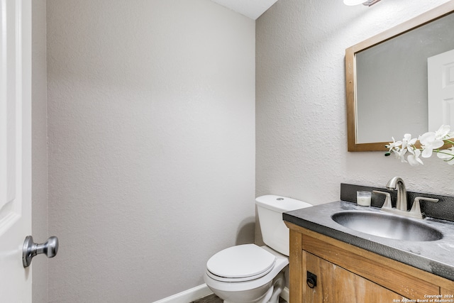 bathroom with toilet and vanity