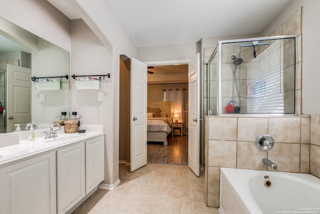 bathroom featuring vanity, shower with separate bathtub, and hardwood / wood-style flooring