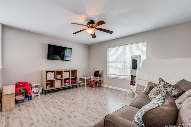 living room with hardwood / wood-style flooring and ceiling fan