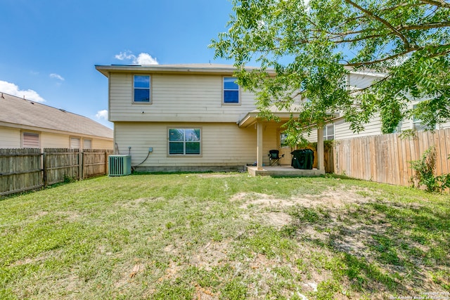 rear view of property with a patio, a lawn, and central AC unit