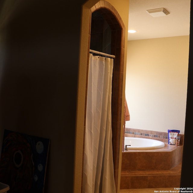 bathroom featuring tiled bath