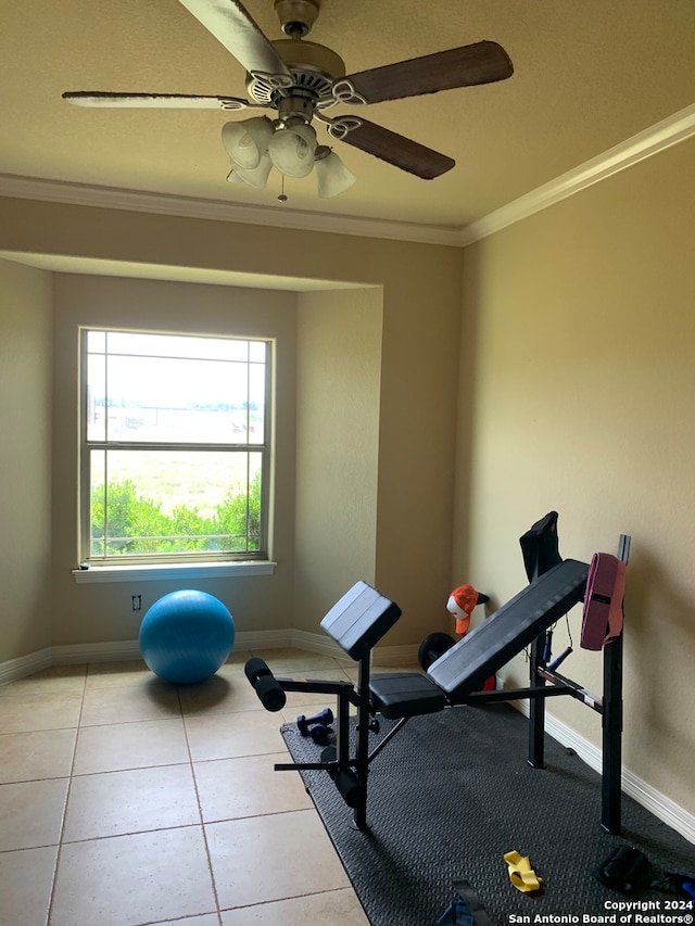 workout area with crown molding, ceiling fan, and tile patterned floors