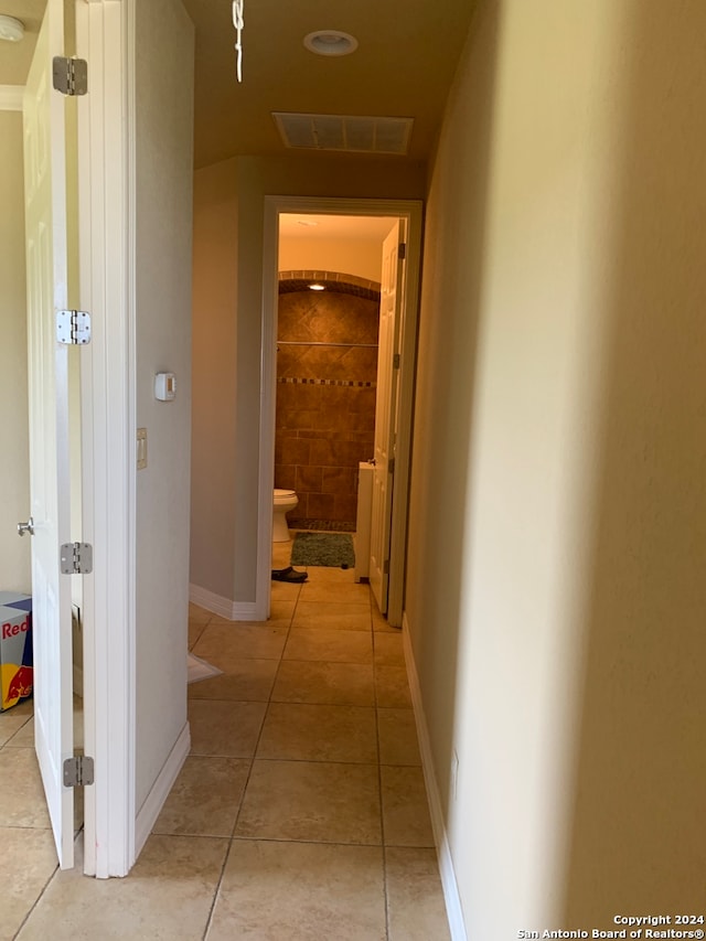 hallway featuring light tile patterned floors