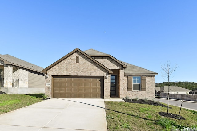 view of front facade with a front yard and a garage