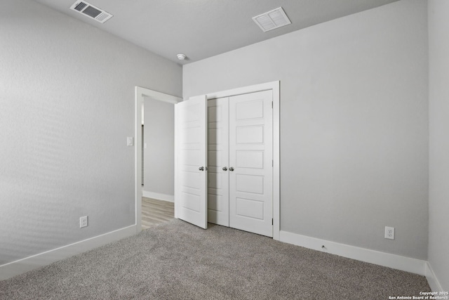 unfurnished bedroom featuring a closet and carpet floors