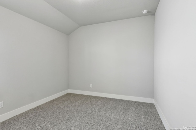 unfurnished room featuring vaulted ceiling and carpet