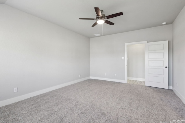 spare room with ceiling fan and carpet