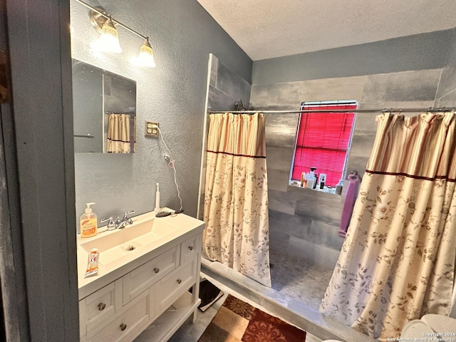 bathroom with vanity, a textured ceiling, and a shower with shower curtain