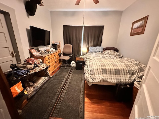 bedroom with ceiling fan and hardwood / wood-style flooring