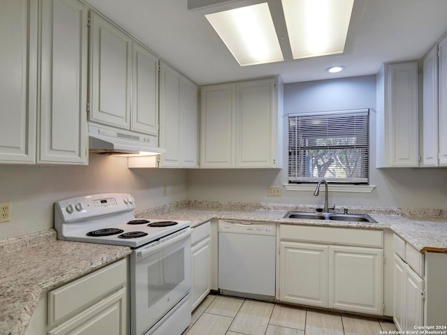 kitchen with sink, white cabinetry, light tile patterned floors, and white appliances