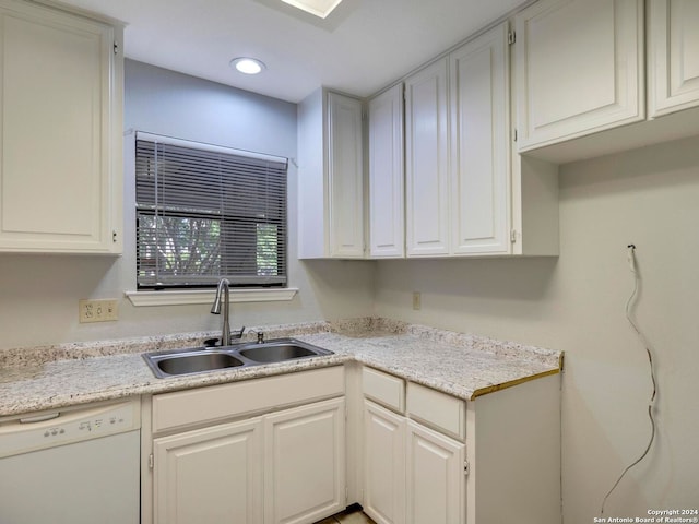 kitchen featuring sink, dishwasher, and white cabinets