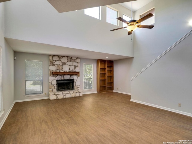 unfurnished living room featuring a fireplace, ceiling fan, and hardwood / wood-style floors