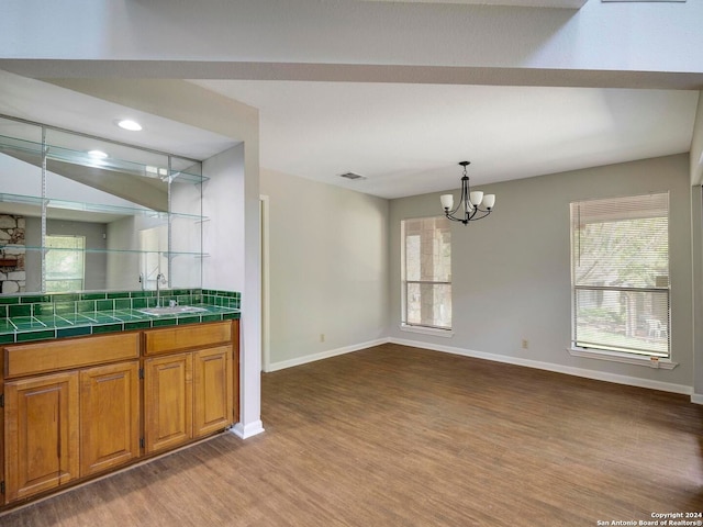 interior space featuring vanity, an inviting chandelier, and hardwood / wood-style flooring