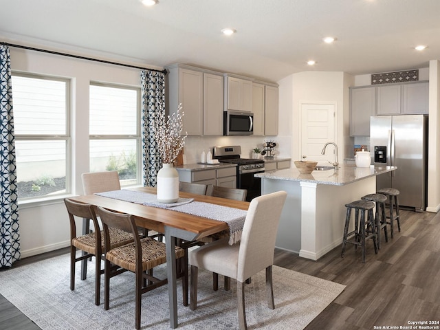 dining space with dark wood-type flooring and sink