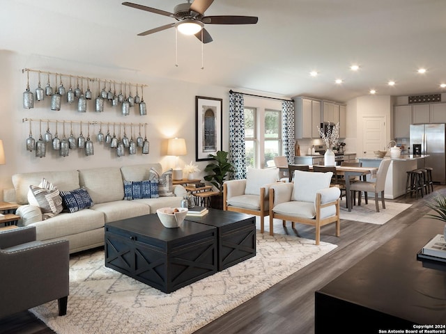 living room with light hardwood / wood-style floors and ceiling fan