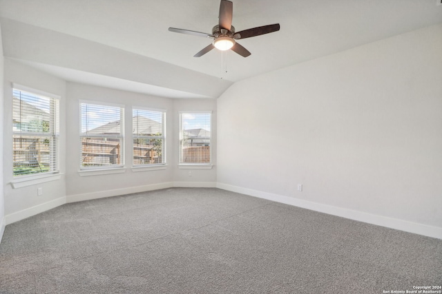 spare room featuring vaulted ceiling, ceiling fan, and carpet floors