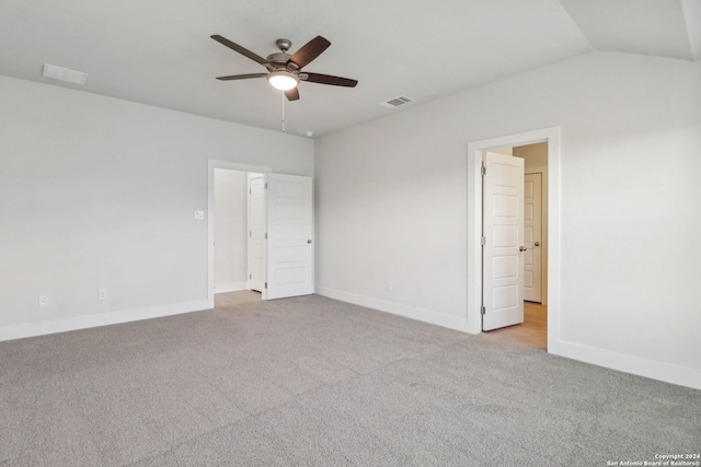 interior space featuring ceiling fan, light carpet, and vaulted ceiling