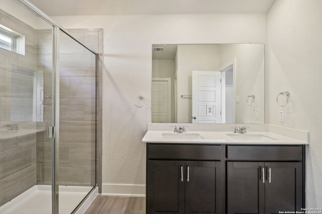 bathroom featuring an enclosed shower, vanity, and hardwood / wood-style flooring