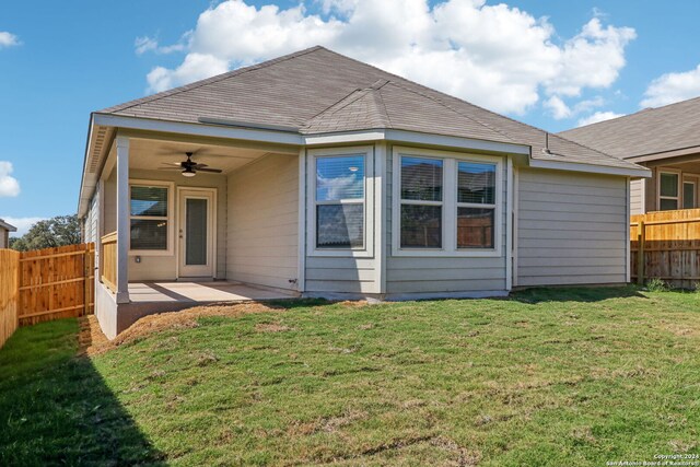 back of property featuring a patio, a lawn, and ceiling fan