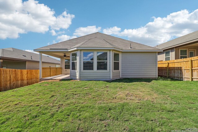 rear view of property with a patio and a yard