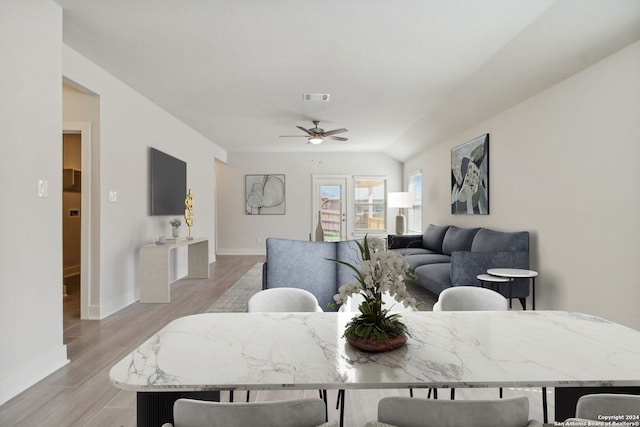 sitting room with carpet flooring, plenty of natural light, and vaulted ceiling