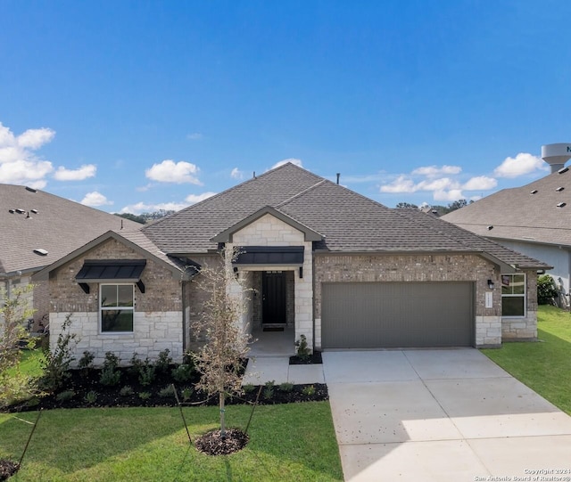 view of front of house featuring a garage and a front lawn