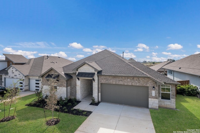 view of front of property with a garage and a front yard