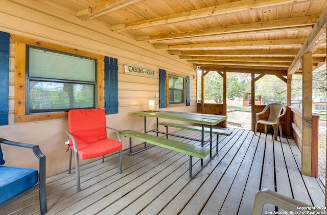 sunroom featuring beamed ceiling and wood ceiling