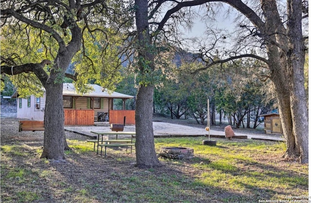 view of yard with an outdoor fire pit