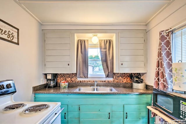 kitchen with dark countertops, a healthy amount of sunlight, white range with electric stovetop, and a sink