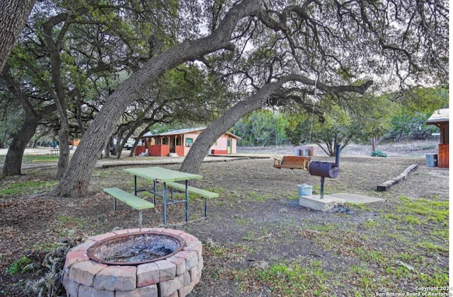 view of yard featuring an outdoor fire pit