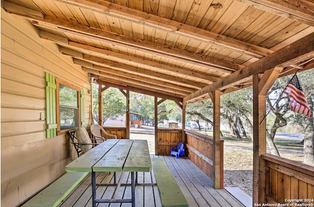 unfurnished sunroom with wooden ceiling and beam ceiling