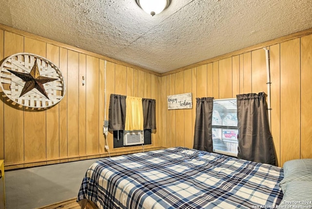 bedroom with wood walls and a textured ceiling