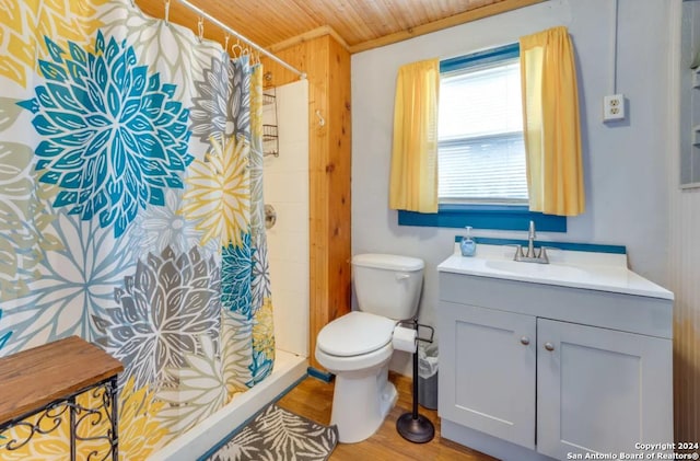 full bathroom featuring toilet, vanity, a shower stall, wood finished floors, and wooden ceiling