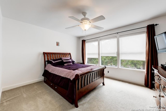 bedroom featuring ceiling fan and light carpet